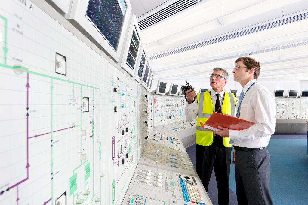 Two engineers monitoring plant systems in a control room